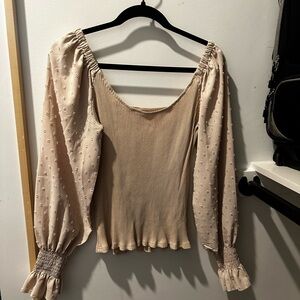 Small long sleeve blouse. Tight to body with puffy sleeves.